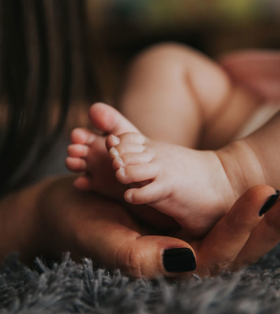 Mother massaging child's feet