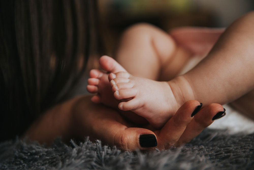 Mother massaging child's feet